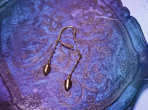 dangly brass ear cuff as seen at free people, featuring constellations and dangling crystals.